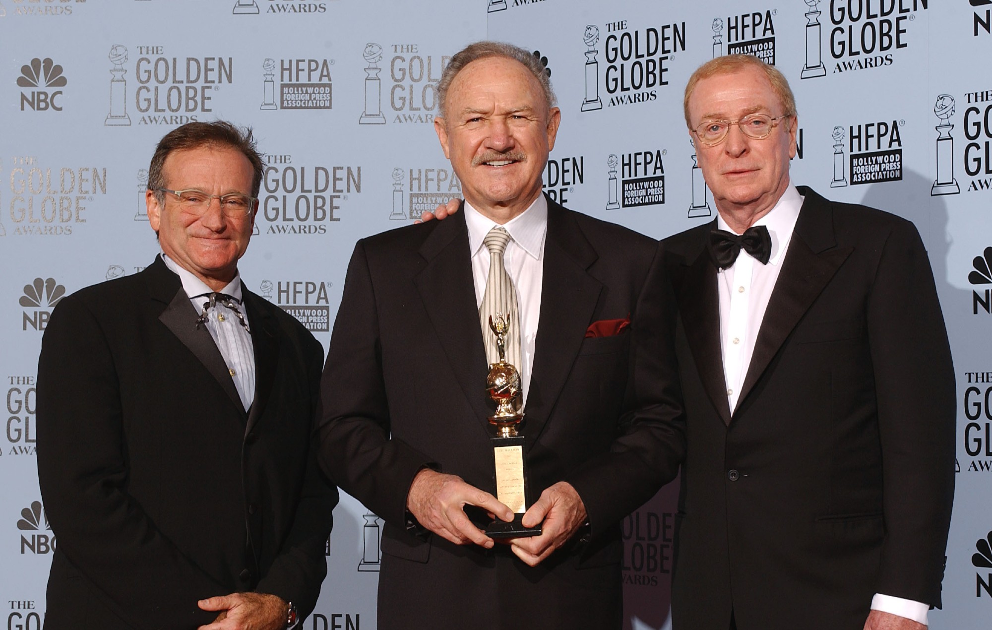 Robin Williams and Michael Caine with Cecil B. DeMille Award winner, Gene Hackman, backstage at the 60th Annual Golden Globe Awards.