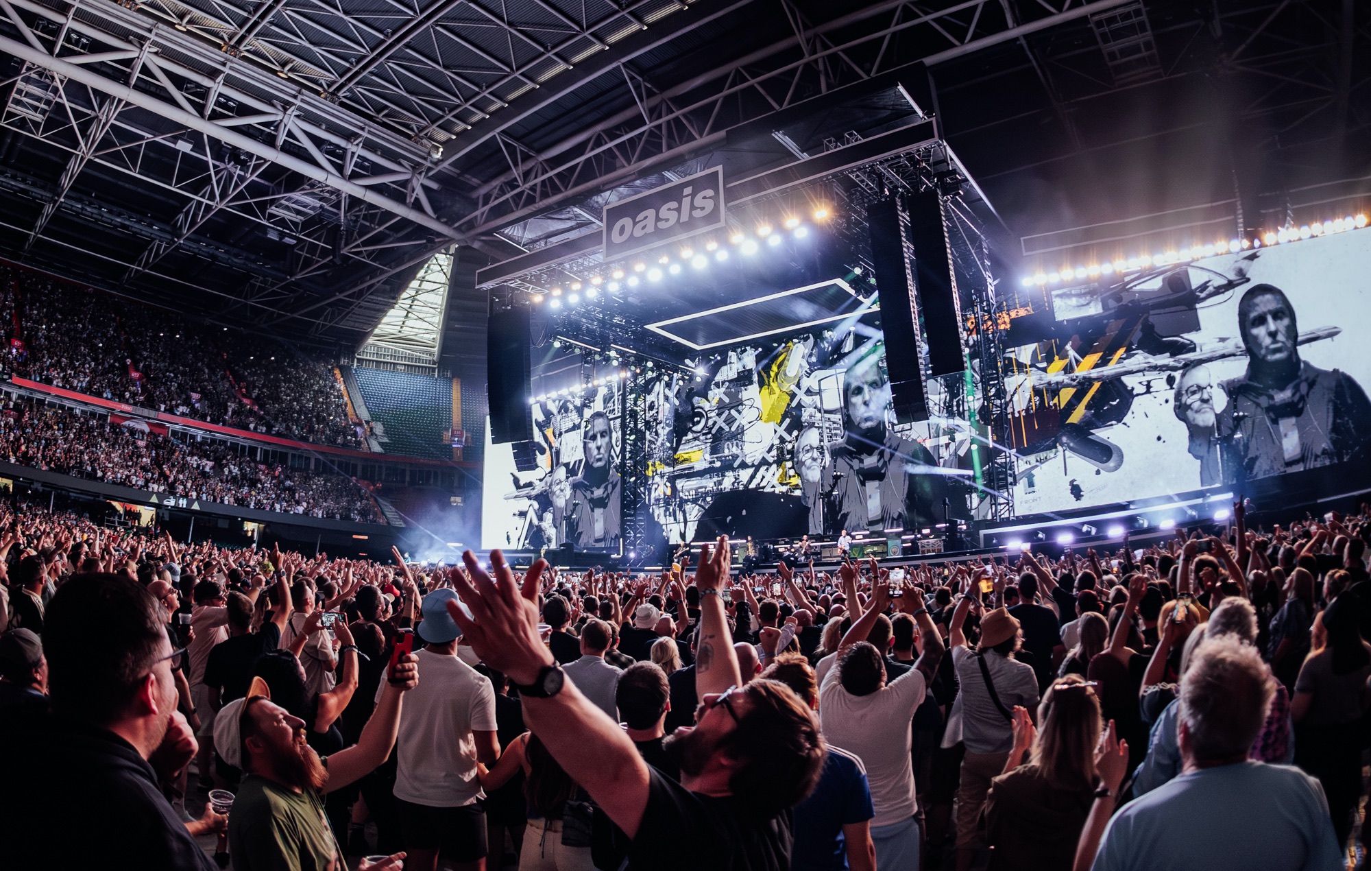crowd watching the first Oasis reunion show in Cardiff, photo by Andy Ford for NME